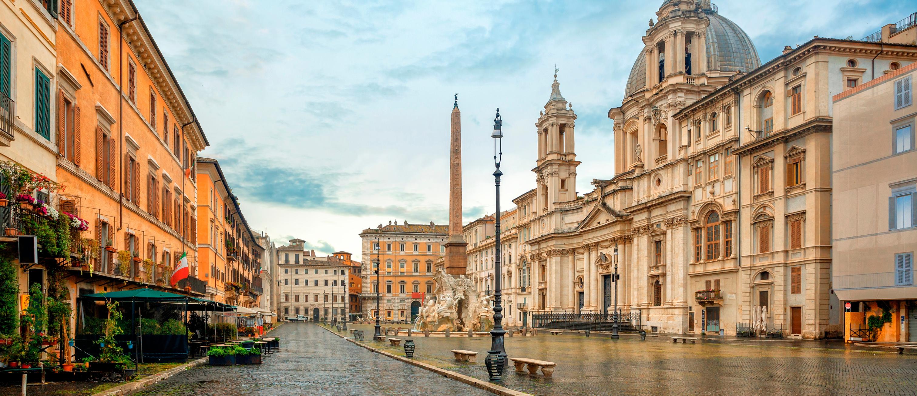 A charming European street with colorful flower shops, traditional buildings with green shutters, and a peaceful cobblestone walkway lined with potted plants and awnings