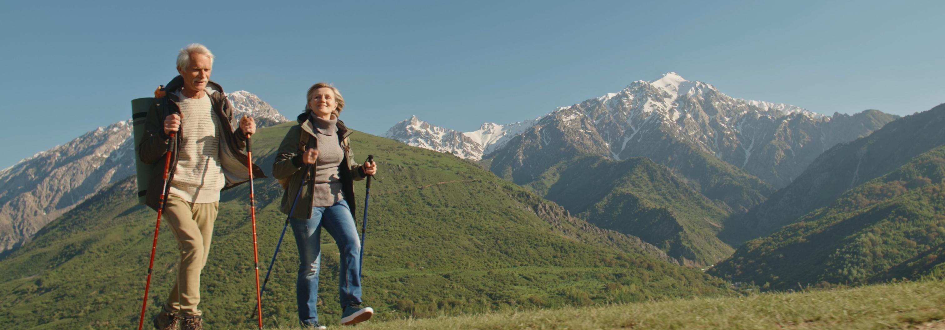 Illustration of a happy older man and woman enjoying vacation in the mountains